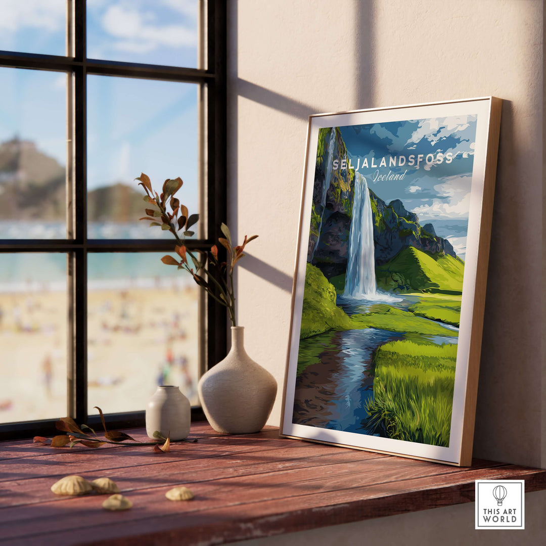 Seljalandsfoss Poster Iceland Print displayed on a wooden table by a sunny window, showcasing the stunning Icelandic landscape.