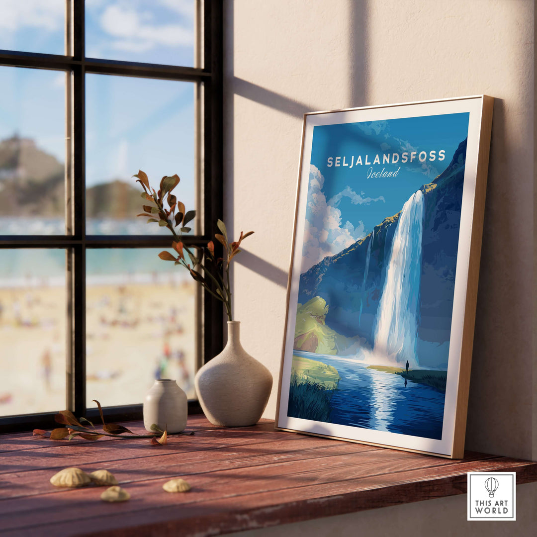 Seljalandsfoss Wall Art Iceland displayed on a table near a window, showcasing the beauty of Iceland's waterfall.