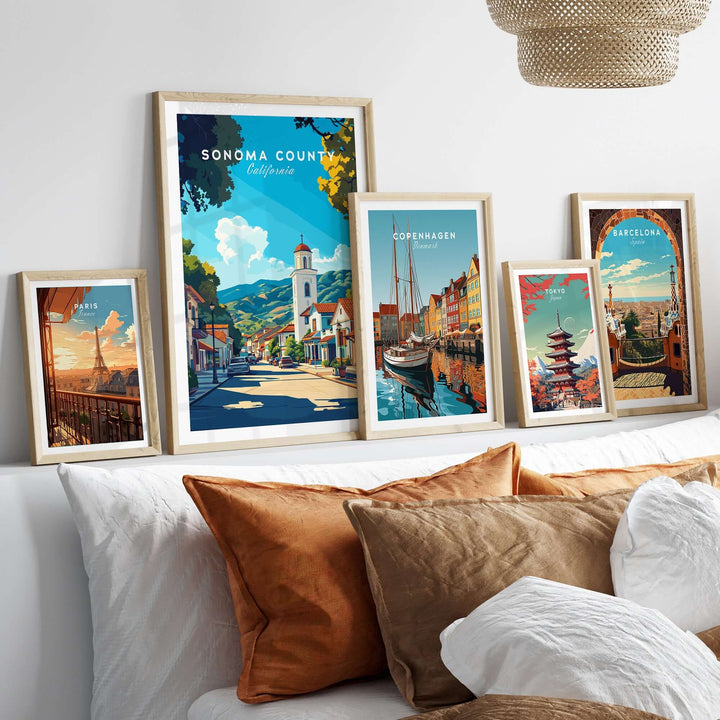 Sonoma County art print alongside travel posters in a cozy bedroom setting with decorative pillows.