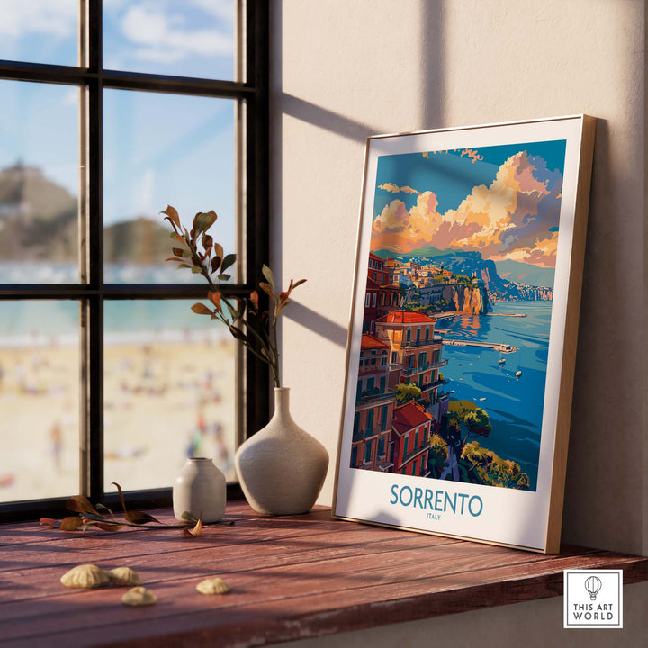 a picture of a beach is on a window sill