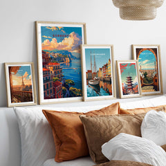 a white bed topped with lots of pillows and pictures