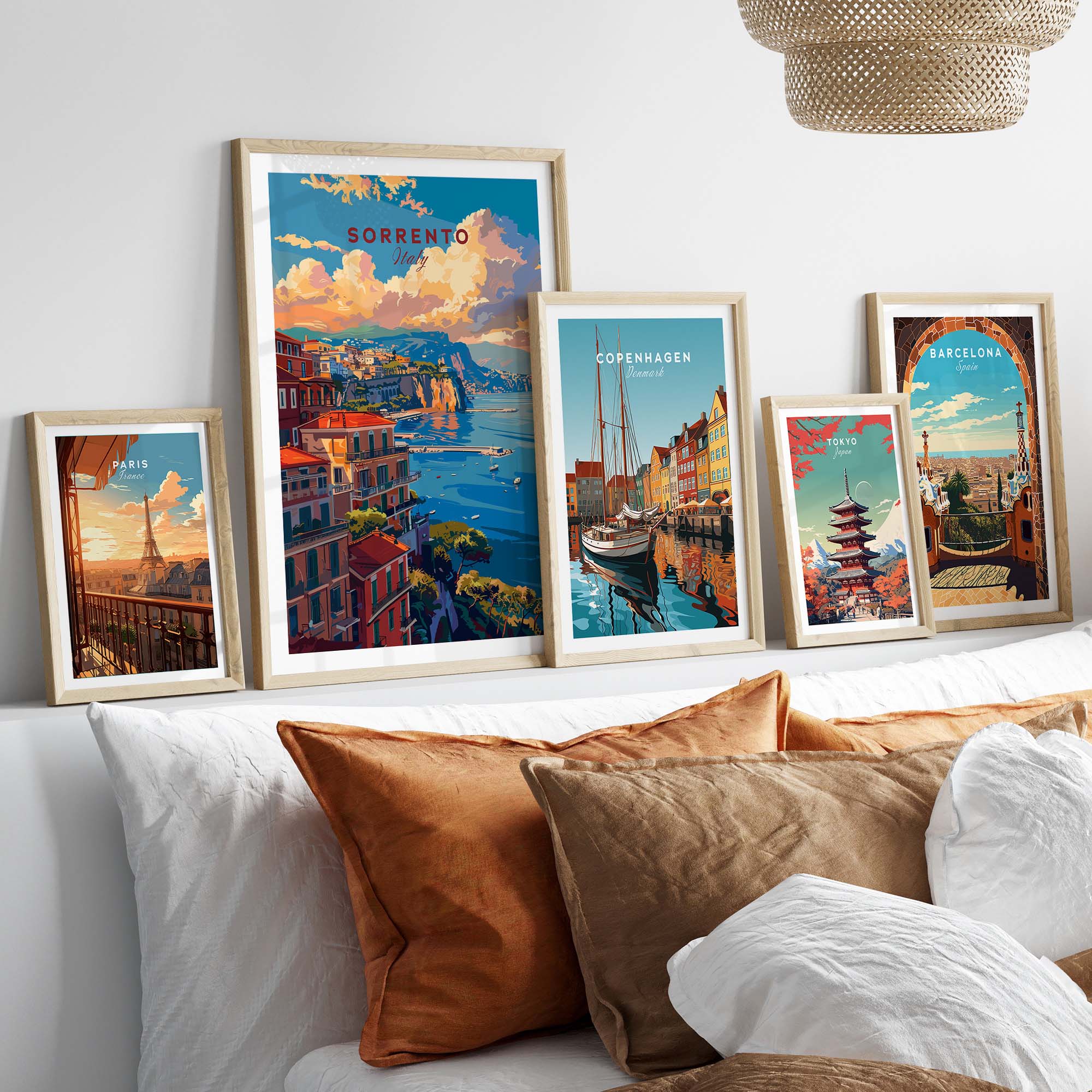 a white bed topped with lots of pillows and pictures
