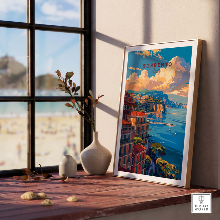 a picture of a beach is on a window sill