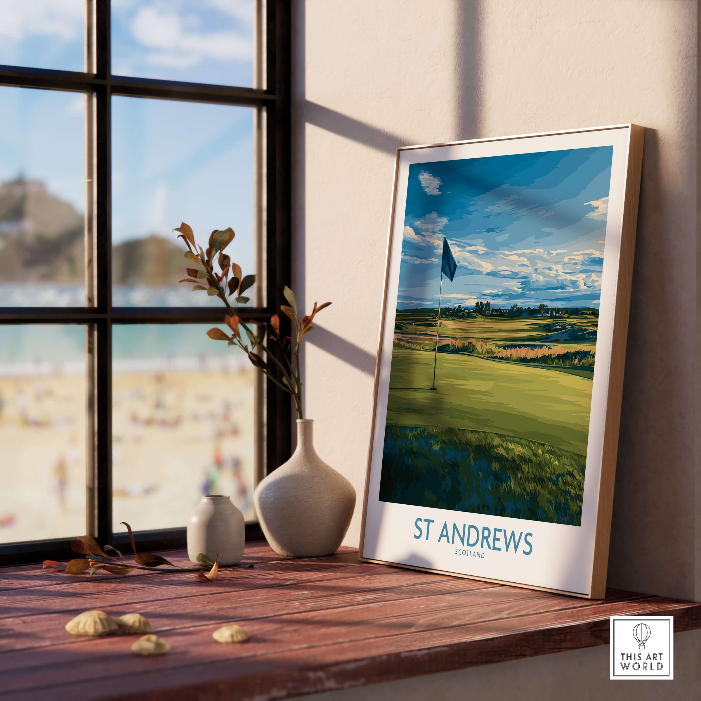 St Andrews Print Scotland - Golf Course Poster on a windowsill with beach view in the background.