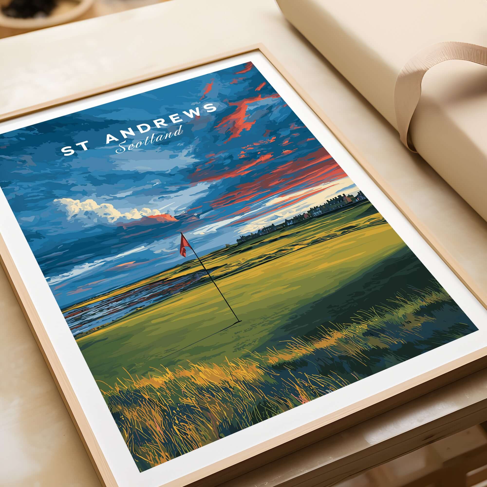 St Andrews Scotland Old Course Green Print - Famous Golf Course Poster displayed on a table with a scenic landscape.