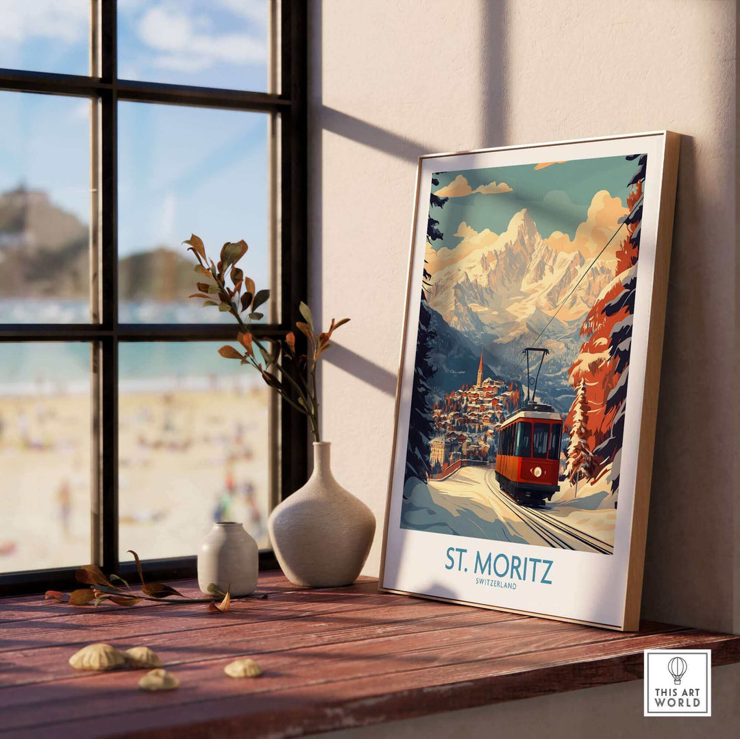 Ski poster of St Moritz, Switzerland with a scenic mountain and cable car view, displayed on a sunlit windowsill.