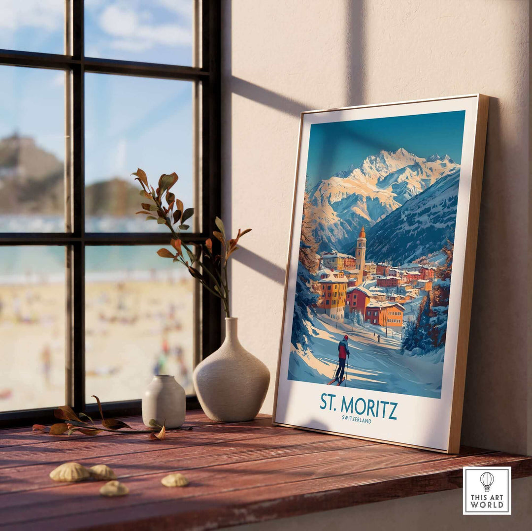 St Moritz ski poster wall art on a windowsill, featuring snowy mountains and a vibrant village scene.