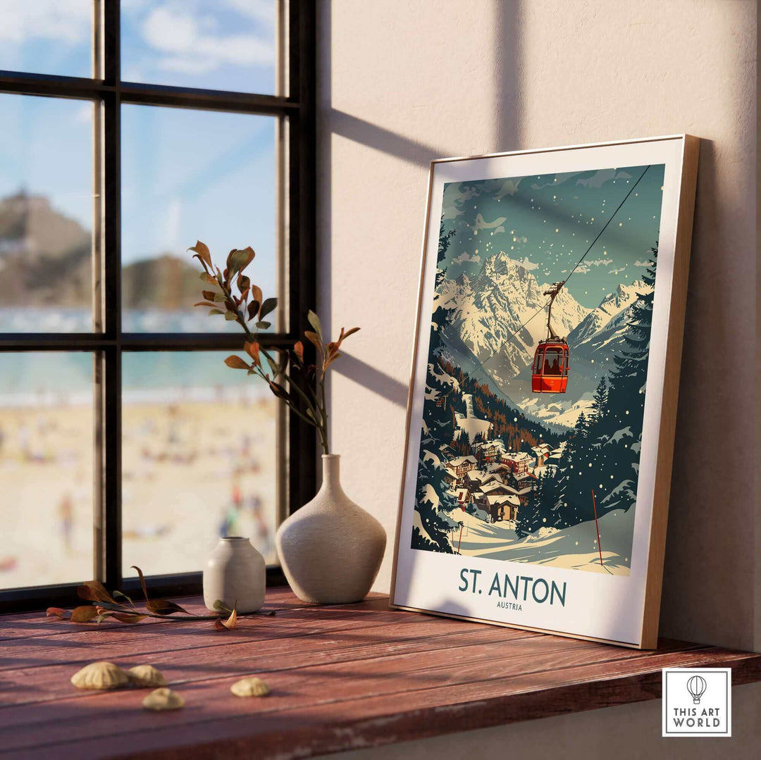 St. Anton Wall Art Ski Poster on a sunny windowsill showcasing snowy mountains and a red gondola lift.