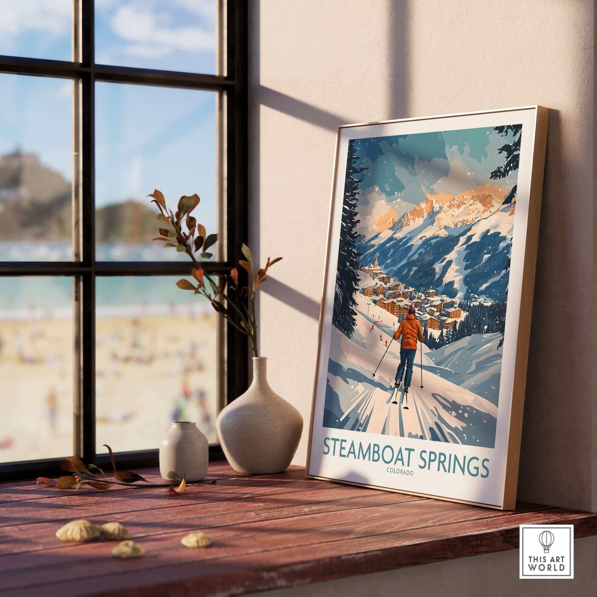 Ski Poster of Steamboat Springs Colorado framed on a windowsill, showcasing snowy mountain scenery and skier.