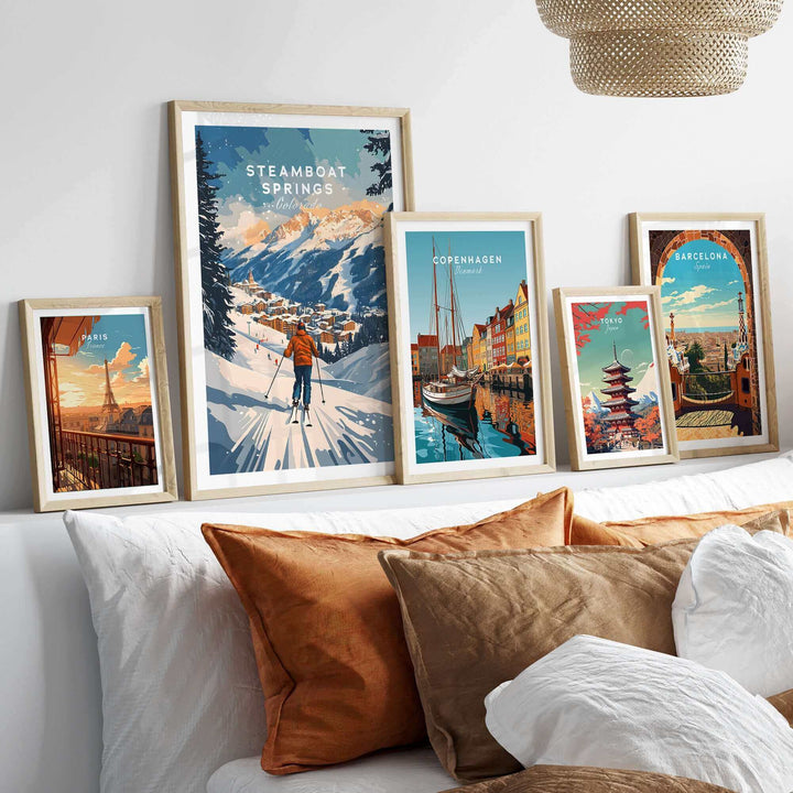 Collection of framed travel posters including a Steamboat Springs ski scene print displayed on a modern bedhead shelf.