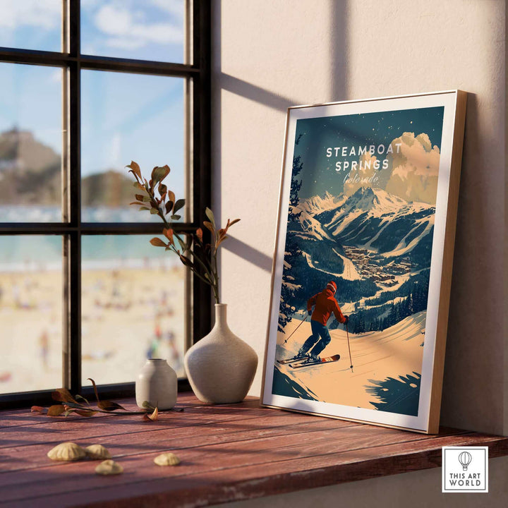 Framed Steamboat Springs Ski Poster on windowsill with mountain scenery in background.