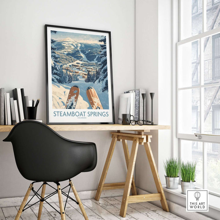 Steamboat Springs ski print showcased in a modern workspace with snow-covered mountains in the background. Perfect ski wall art.