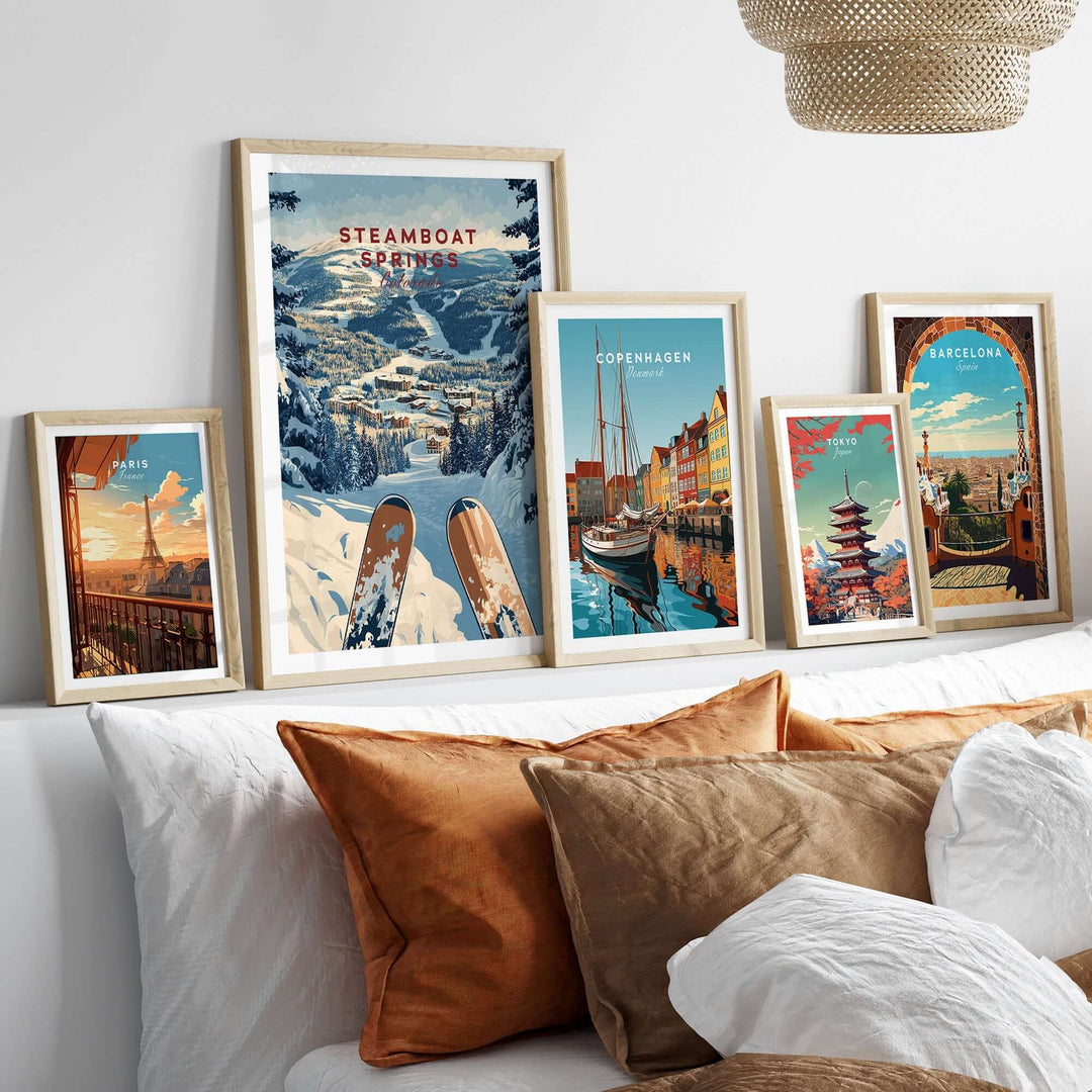 A cozy living room featuring a Steamboat Springs travel poster among other vibrant city posters and decorative pillows.