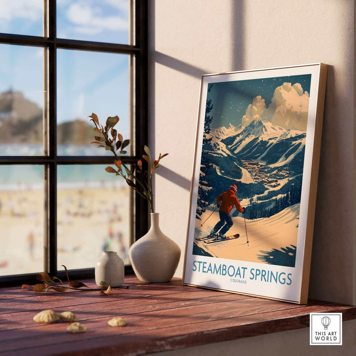 Ski poster of Steamboat Springs, Colorado, displayed on a windowsill, depicting a skier against a snowy mountain backdrop.