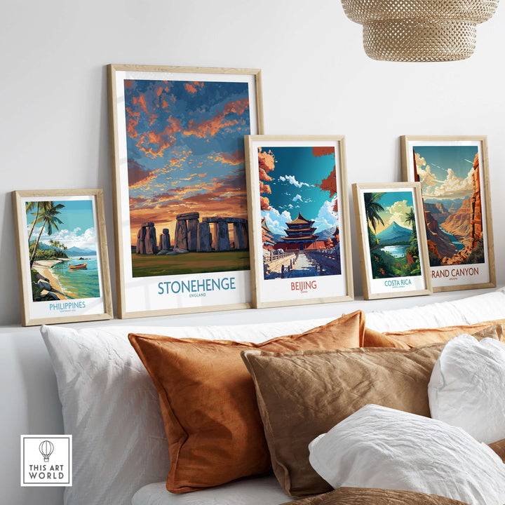 Framed travel posters on a wall, featuring Stonehenge and vibrant landscapes from various countries.