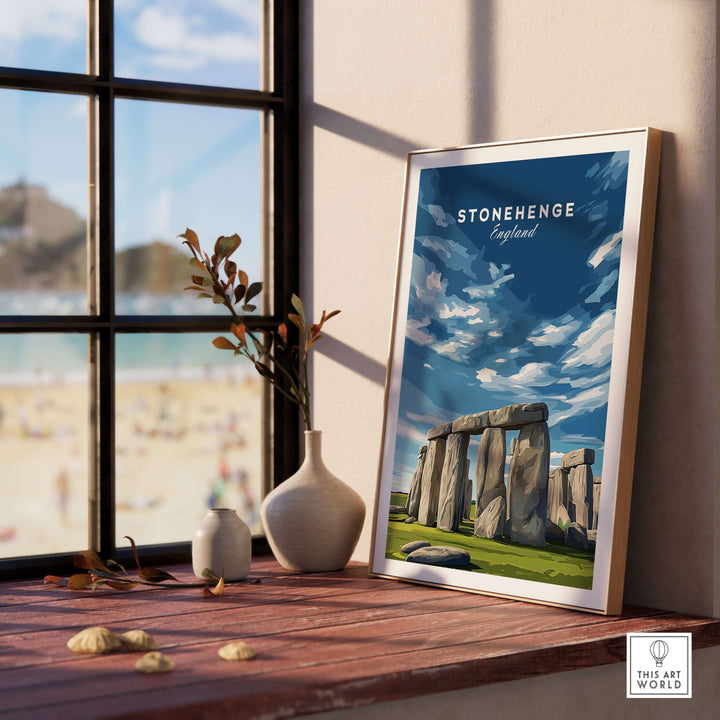 Framed Stonehenge print in a sunny interior, showcasing the iconic monument and scenic landscape of Wiltshire, England.