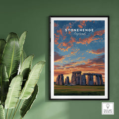 Stonehenge Travel Print - English Countryside Poster - Historic Landmark Wall Art displayed on a green wall with plants.