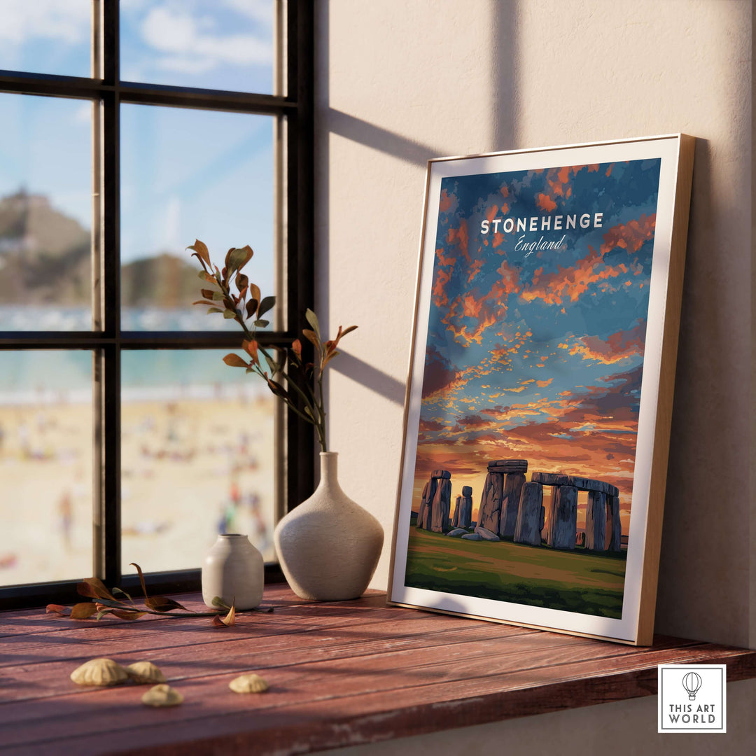 Stonehenge travel print framed on a rustic table, showcasing the English countryside and historic landmark.