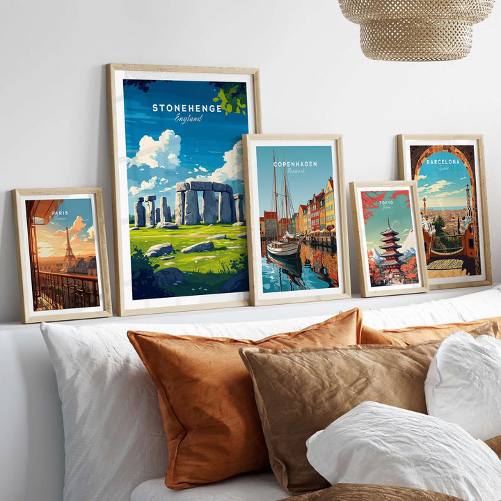 Framed Stonehenge travel print alongside other city posters in a cozy living room setting.