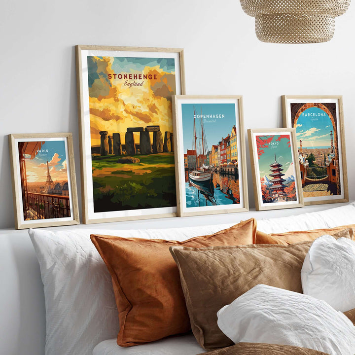 Framed Stonehenge and travel posters on a stylish wall, showcasing iconic landscapes and cultural heritage.