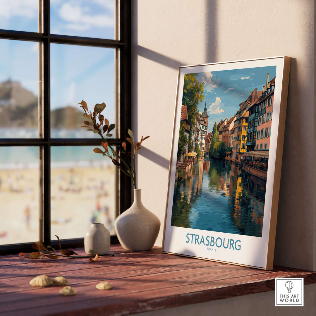 Strasbourg France Art Print | Petite France Travel Poster displayed beside a window showcasing vibrant canal views.