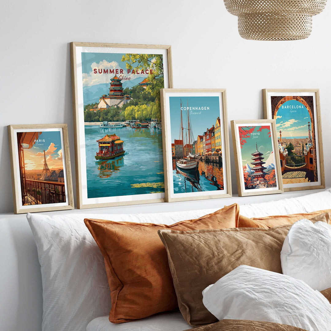 Framed Summer Palace poster with lake view and other city art prints on a decorative wall above a cozy sofa.