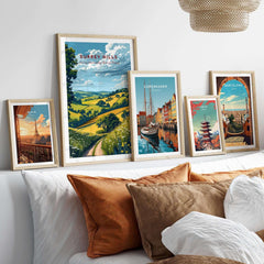 Surrey Hills Poster beautifully displayed among framed travel posters on a cozy bed.