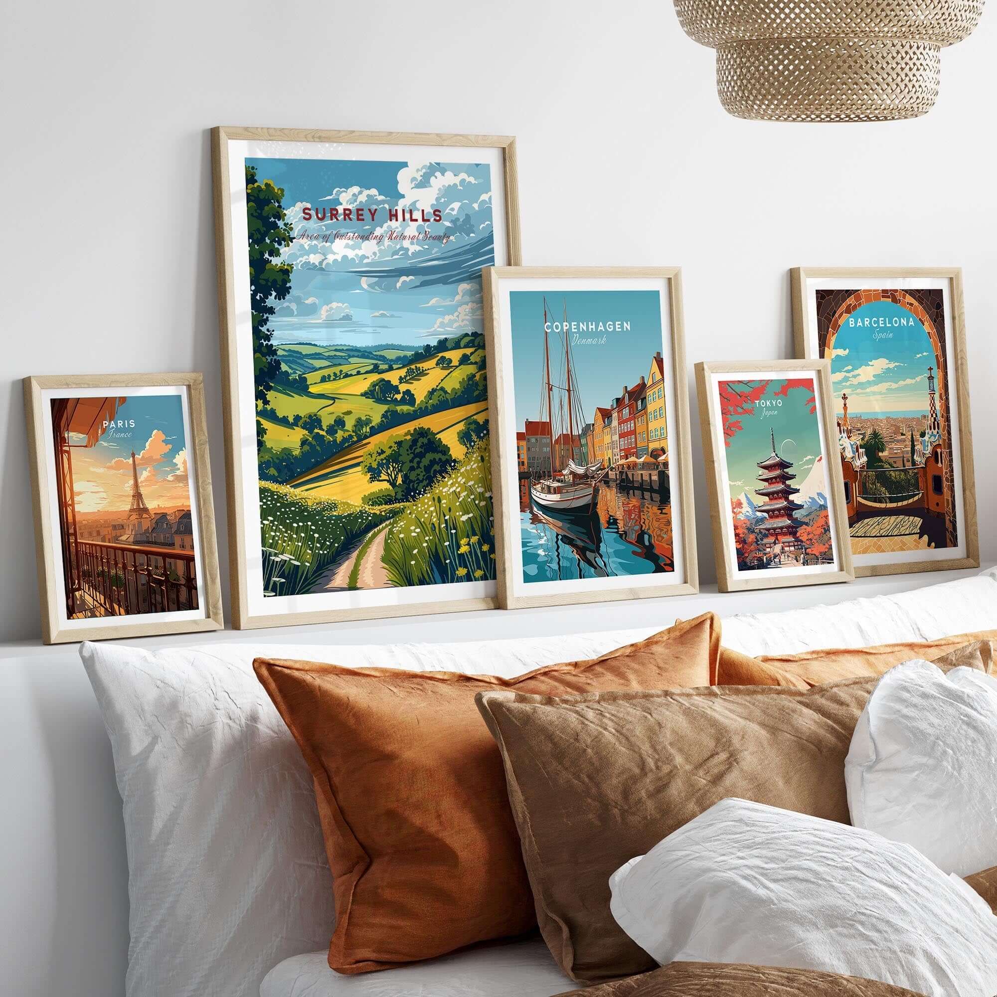 Surrey Hills Poster beautifully displayed among framed travel posters on a cozy bed.