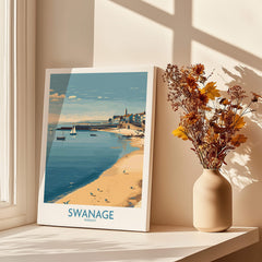 Swanage Dorset Canvas Print | Scenic Bay Poster displayed on a windowsill with vase of flowers.