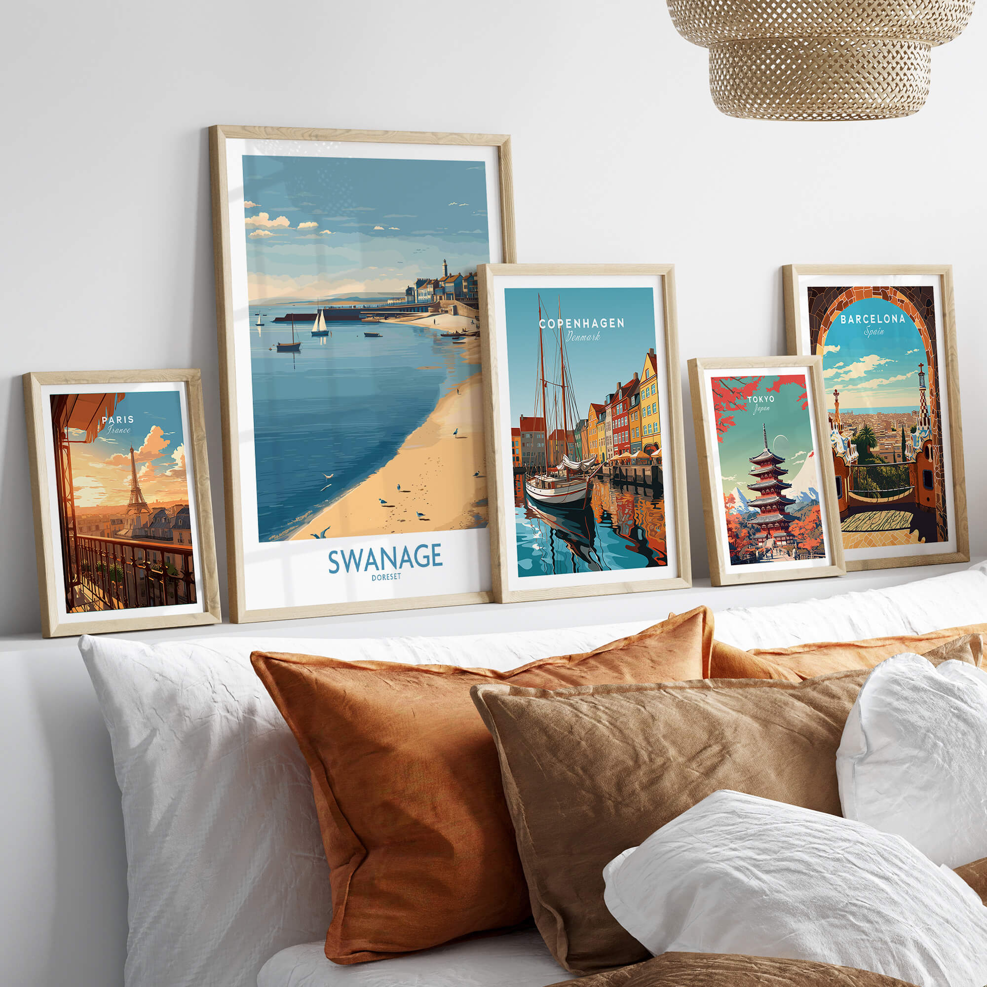 Swanage Dorset Canvas Print | Scenic Bay Poster displayed among travel-themed art prints on a cozy sofa.