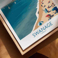 Swanage Dorset Poster | White Cliffs & Coastal Sailboat Scene Canvas Print displayed on wooden table.