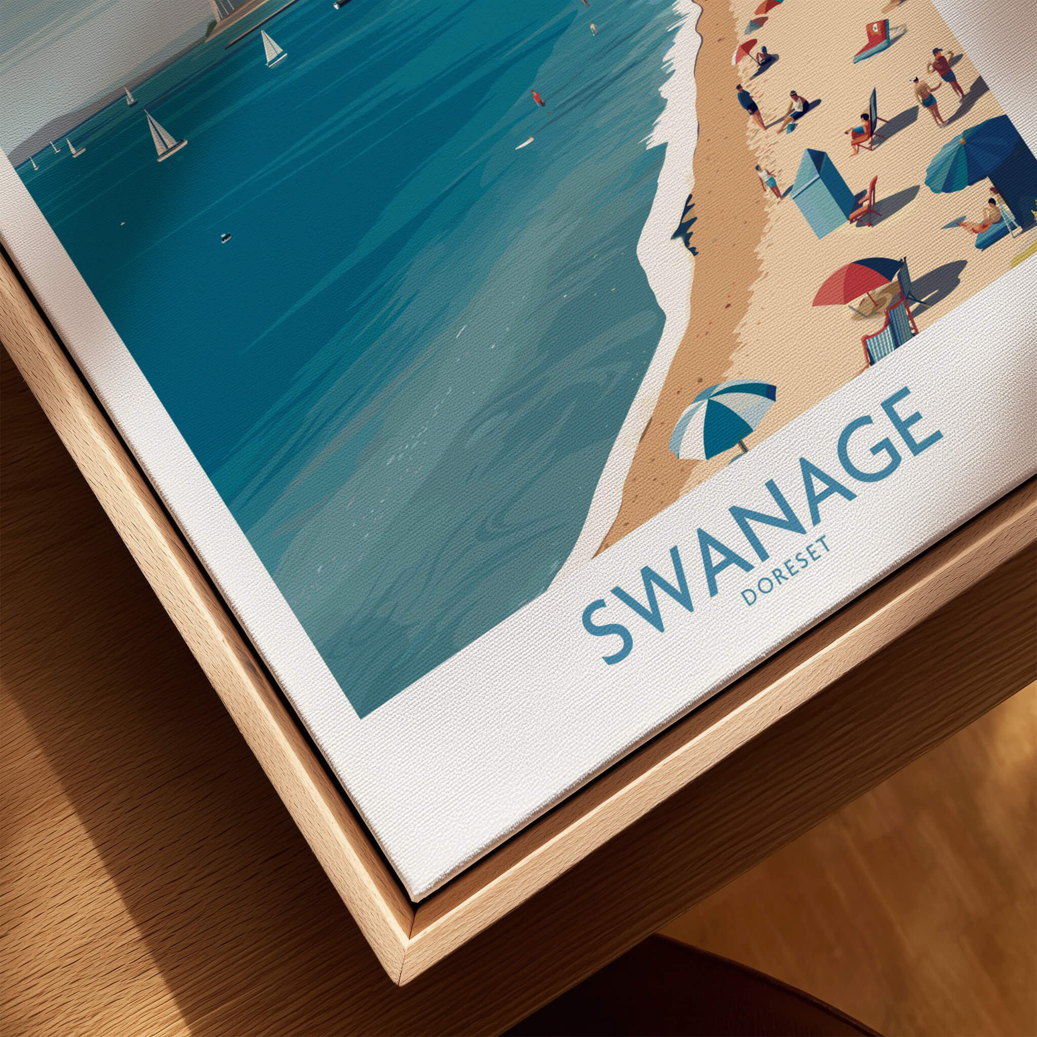 Swanage Dorset Poster | White Cliffs & Coastal Sailboat Scene Canvas Print displayed on wooden table.