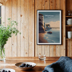 Swanage Print Dorset Wall Art | Old Harry Rocks Coastline Travel Poster displayed in a cozy wooden interior.