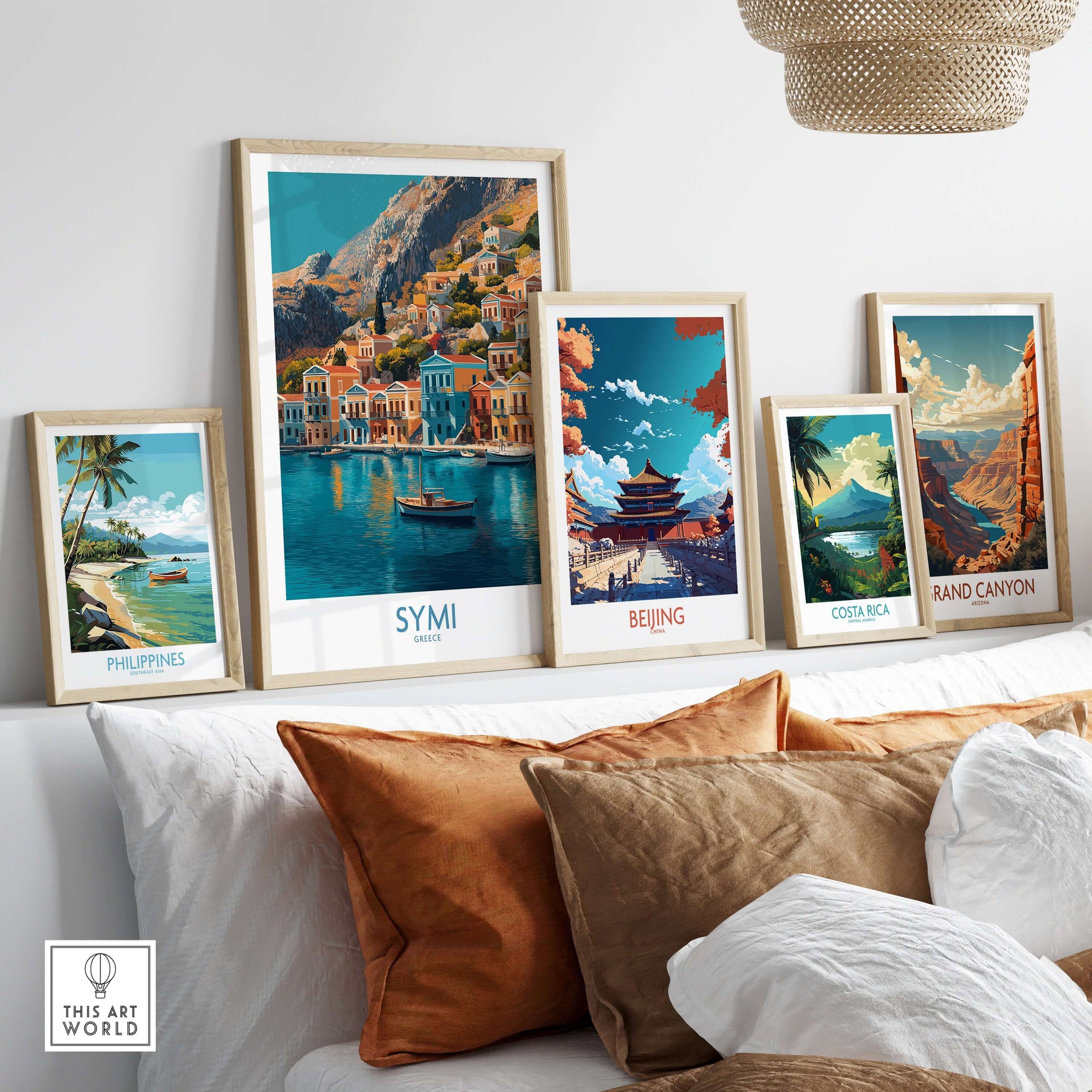 Symi Greece Poster displayed among travel-themed art prints on a cozy sofa backdrop.