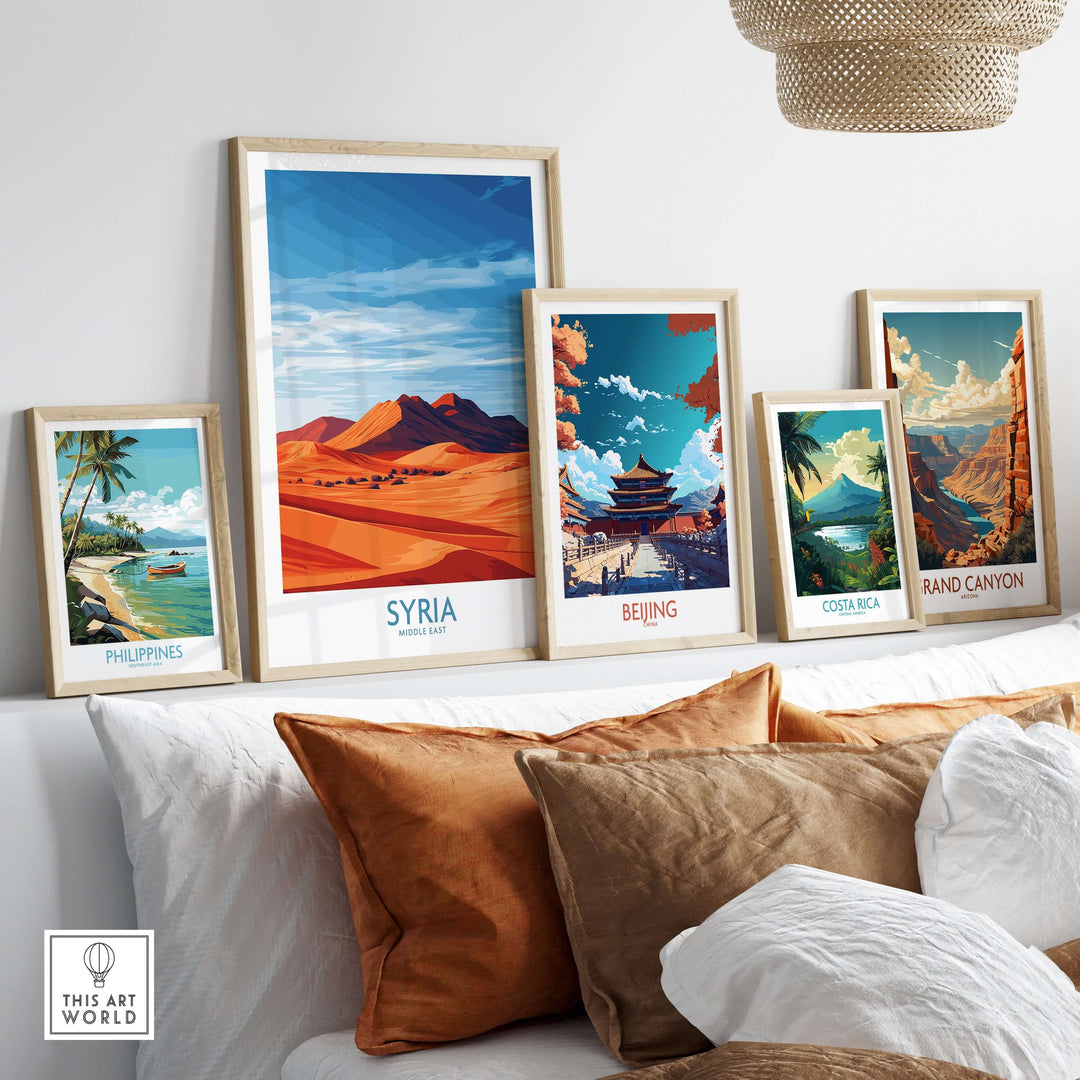 Collection of travel posters featuring Syria, Beijing, Costa Rica, and the Philippines on a stylish couch.