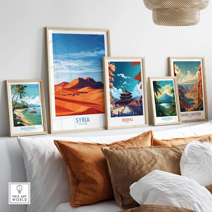 Collection of travel posters featuring Syria, Beijing, Costa Rica, and the Philippines on a stylish couch.