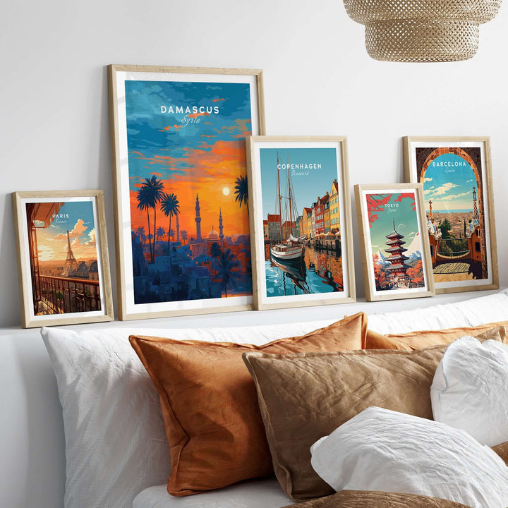 Framed Damascus sunset print among other city artworks, enhancing home decor with vibrant colors and cultural themes.