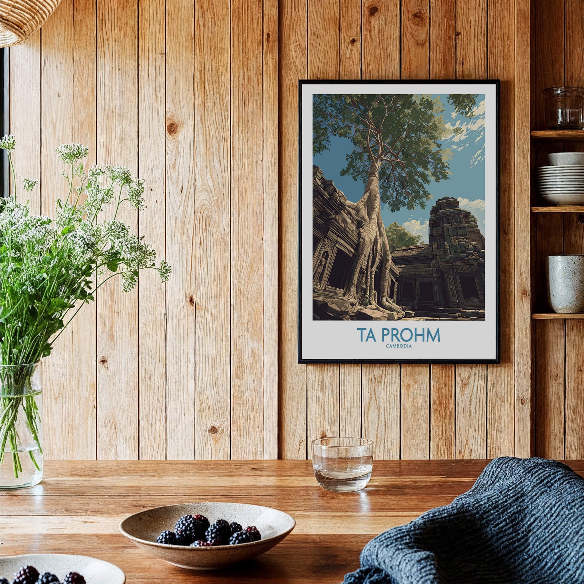Ta Prohm Cambodia Poster | Sunset Jungle Temple Scene Canvas Print displayed on wooden wall with plants and table.