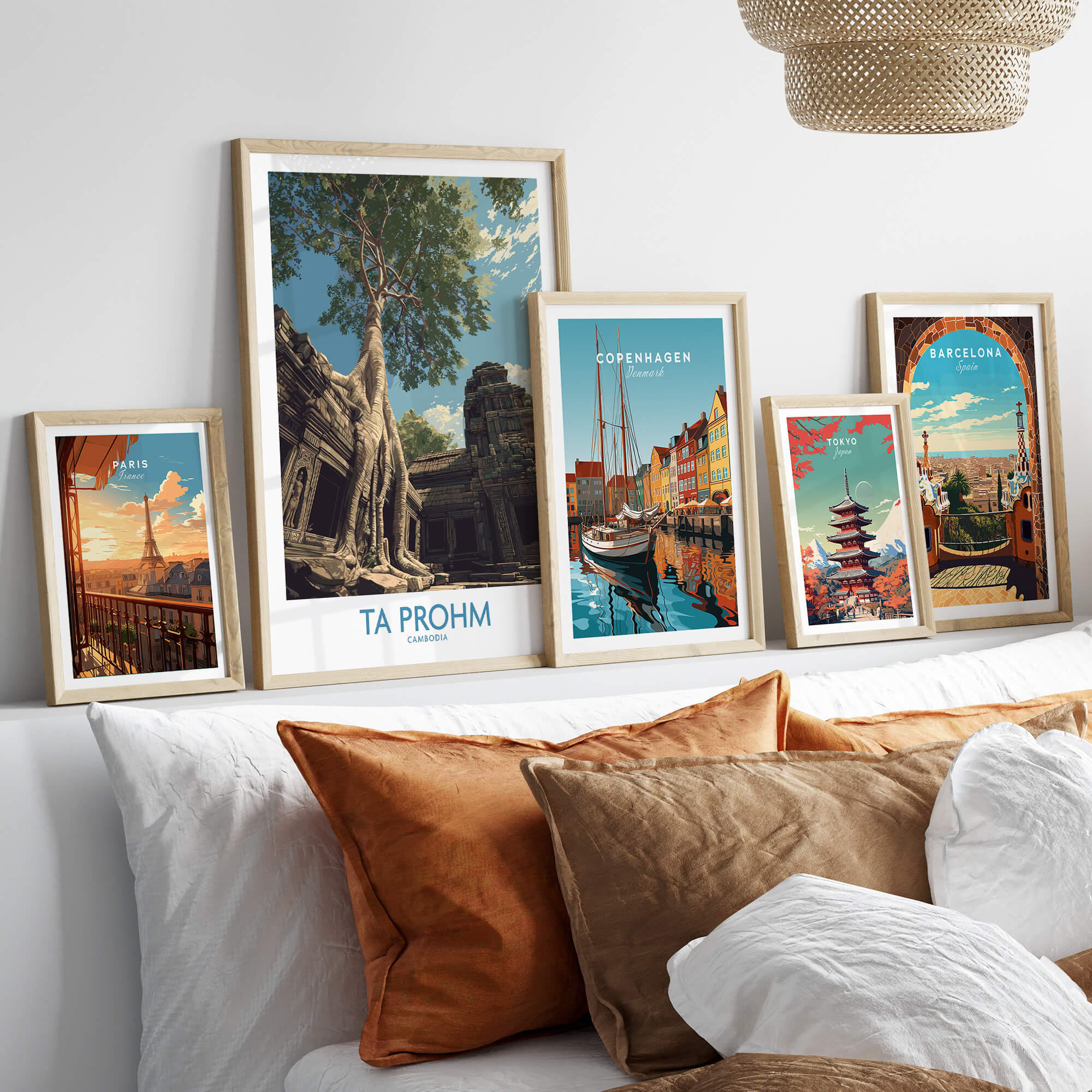 Ta Prohm Cambodia Poster | Sunset Jungle Temple Scene Canvas Print displayed among framed travel posters on a cozy sofa.