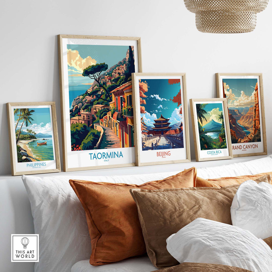 Collection of framed travel prints including Taormina Travel Print displayed on a white shelf above a cozy couch