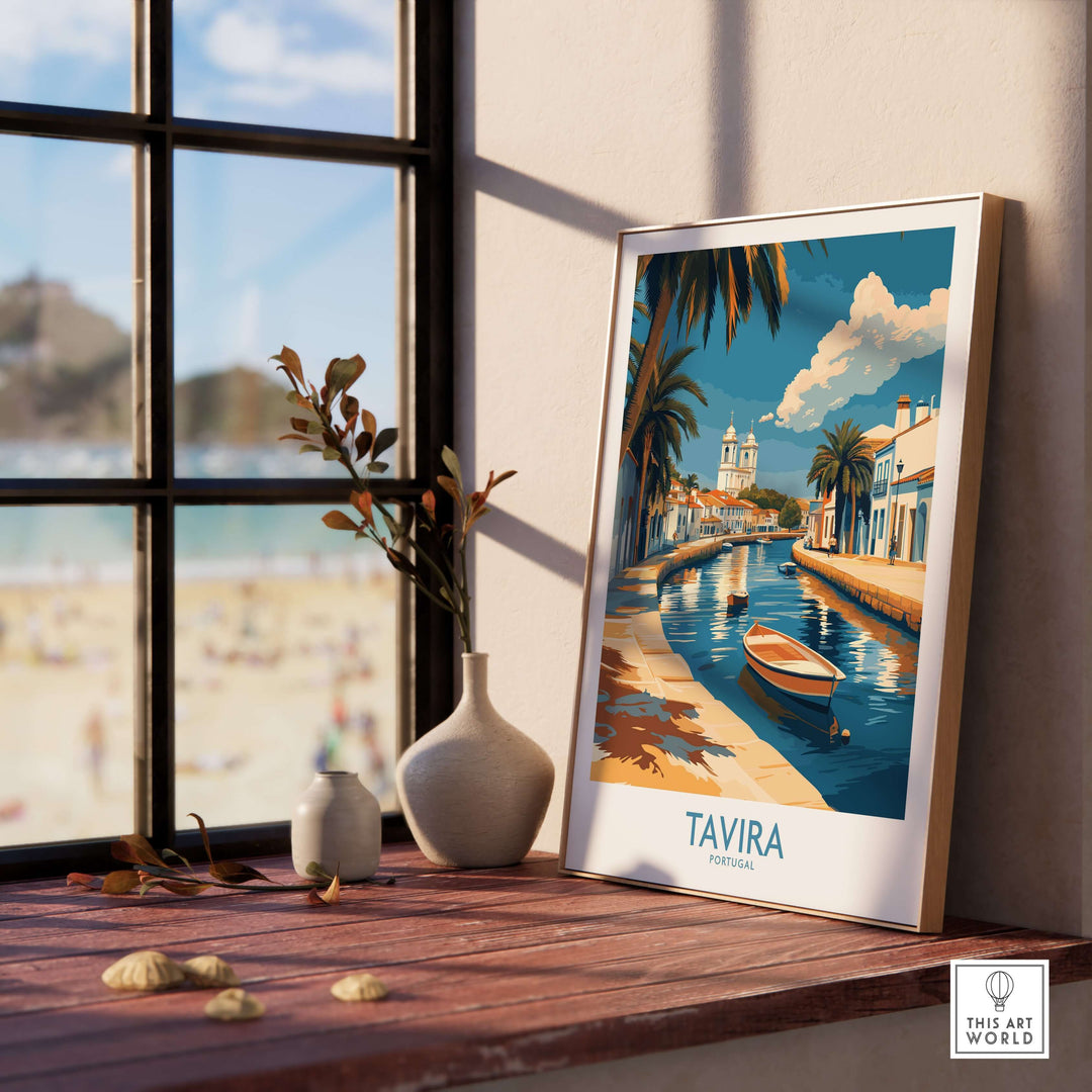 Tavira Riverside poster depicting serene Portuguese landscape with boat and palm trees, showcased in bright indoor setting.
