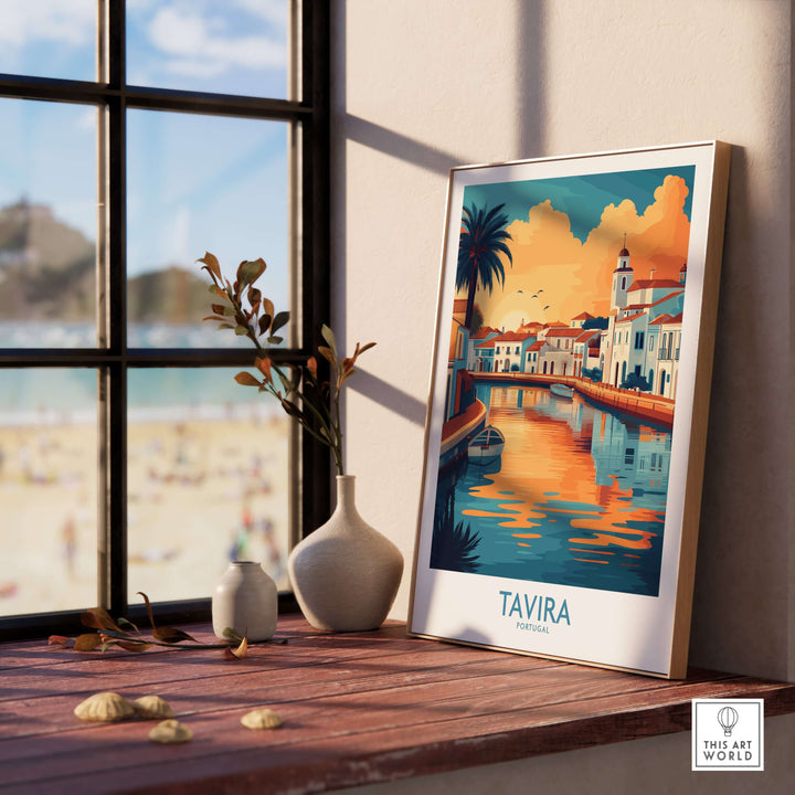 Tavira Sunset poster framed on a windowsill showcasing vibrant colors of Algarve, Portugal's coastal town.