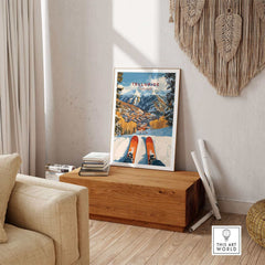 Telluride Ski Poster displayed on a wooden bench in a cozy living room setting with mountain scenery artwork.