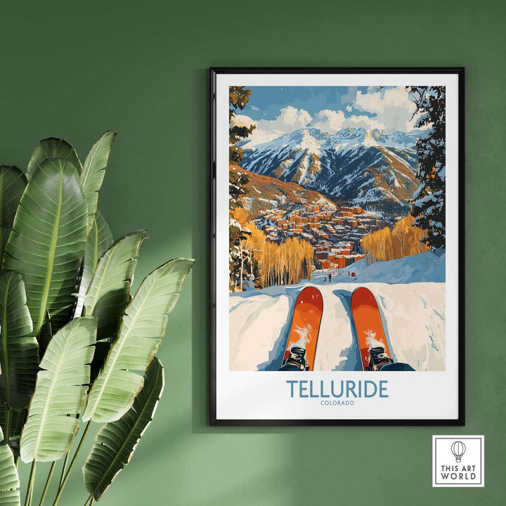 Telluride wall art ski poster featuring vibrant ski scene in Colorado mountains, framed on a green wall with plant.