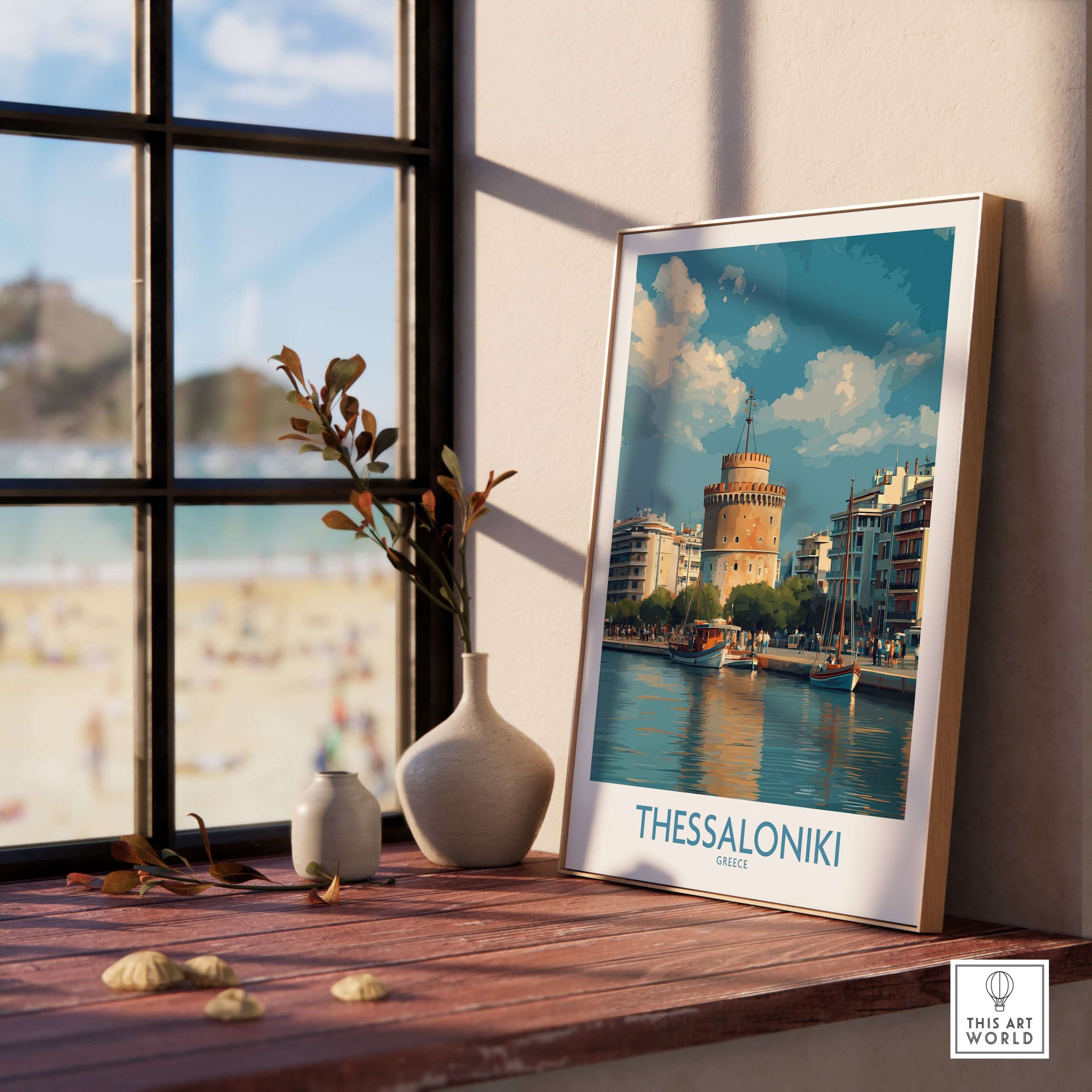 Thessaloniki Greece Poster | Historic Port Scene Print displayed on a wooden table near a window with a beach view.