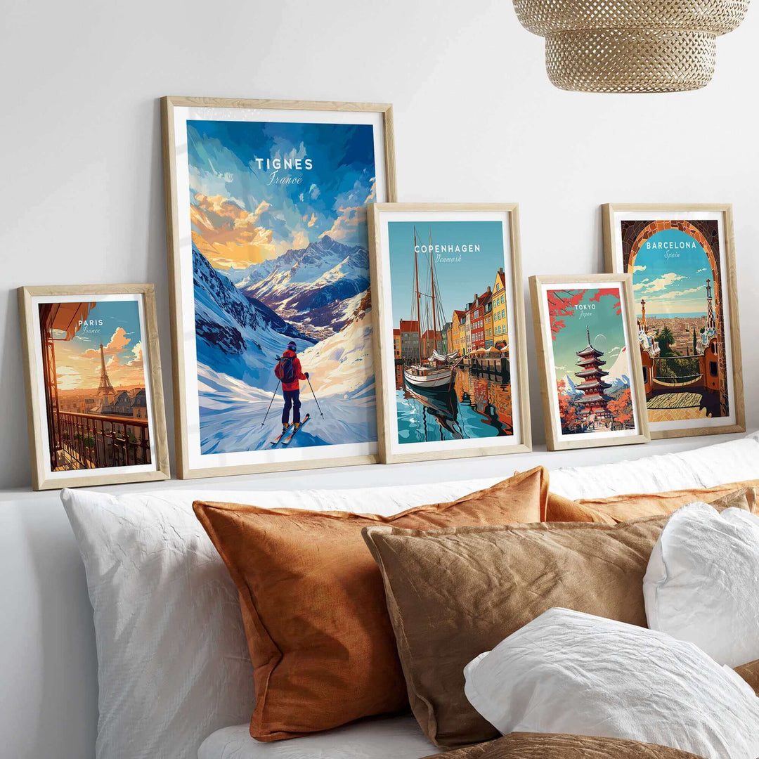 Collection of vibrant travel posters featuring Tignes ski scene and European cityscapes displayed on a cozy bedhead.