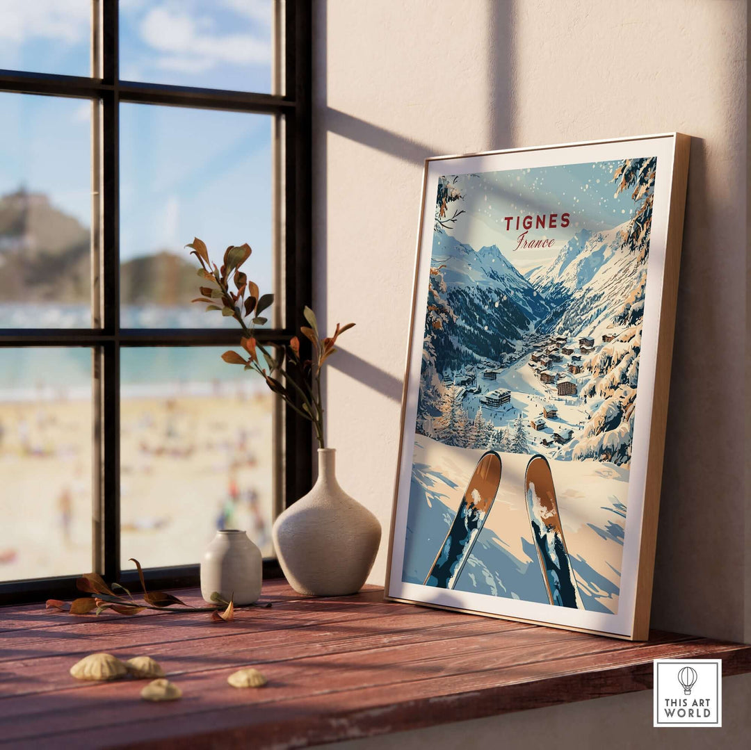 Tignes travel poster featuring snowy mountains and ski slopes, displayed beside a window with a beach view. Perfect for winter sports lovers.