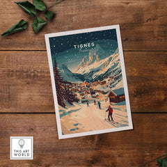 Vintage-style Tignes ski resort wall art print on rustic wooden table with green leaves, showcasing snowy mountain landscape.