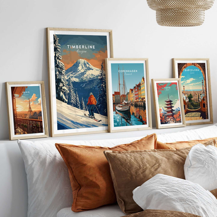 Framed Timberline Travel Poster and other city posters displayed on a cozy bed with decorative pillows.