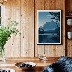Tofino Canada Wall Art Print | Wilderness Lake and Mountain Travel Poster framed on a wooden wall with greenery.
